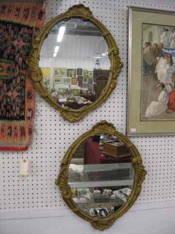 Appraisal: Pair of Carved Oval Mirrors '' x '' gold finish