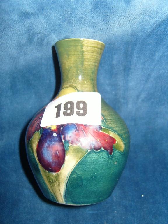 Appraisal: A small green ground Moorcroft vase with drawn neck and