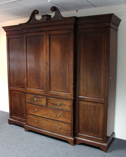 Appraisal: An Edwardian inlaid triple wardrobe of breakfront form the broken