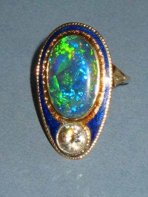 Appraisal: A DIAMOND AND BLACK OPAL DRESS RING comprising single brilliant