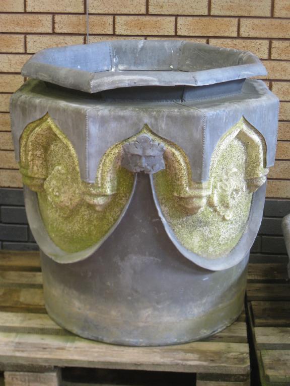 Appraisal: A th Century lead and composite stone Well Head gargoyles