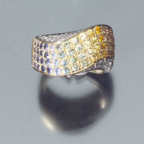 Appraisal: Undulating k yellow gold band with a rainbow of sapphires