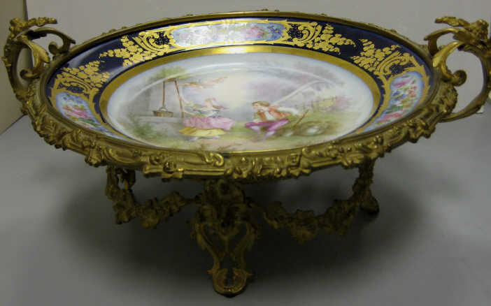 Appraisal: SEVRES STYLE PORCELAIN AND GILT METAL TAZZA A charger decorated