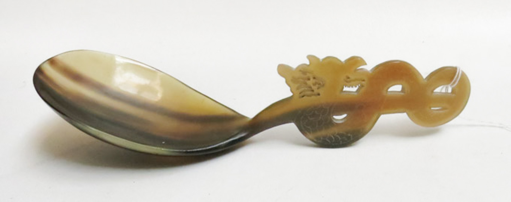 Appraisal: CHINESE CARVED OX HORN SERVING SPOON the handle a serpentine