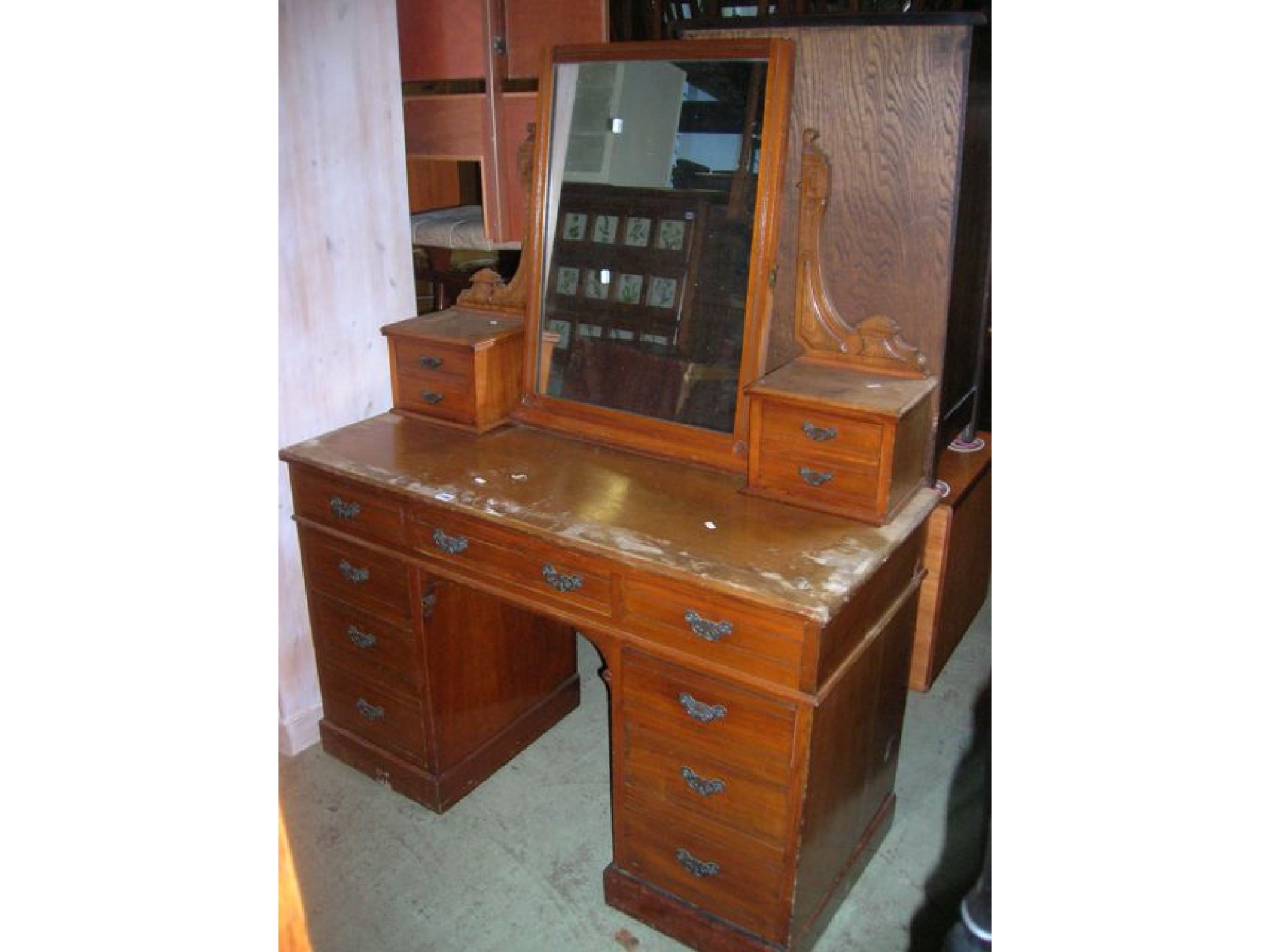 Appraisal: A late Victorian walnut kneehole twin pedestal dressing table with