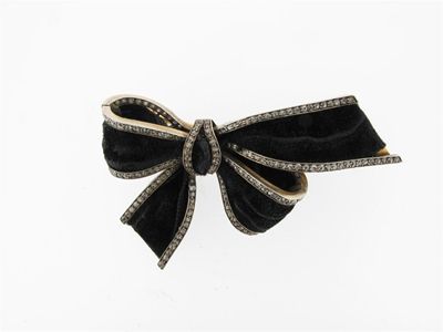 Appraisal: A black fabric tied bow brooch Mounted in silver on