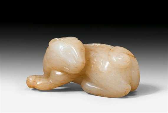 Appraisal: A WHITE JADE TIGER WITH BROWN INCLUSIONS China Ming dynasty