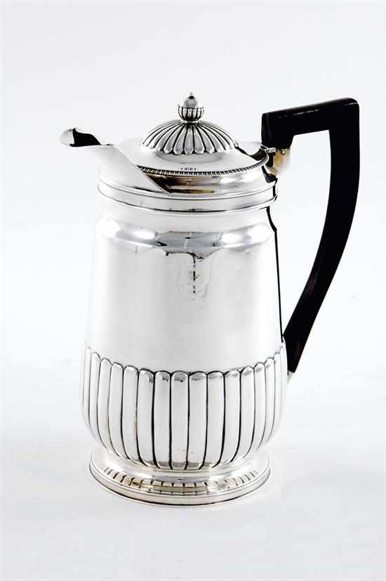 Appraisal: Georgian sterling hot milk jug London dated hinged reeded and