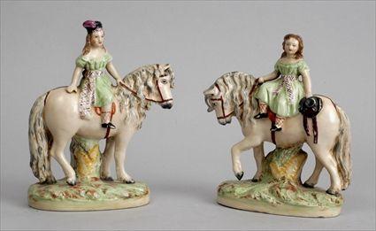 Appraisal: PAIR OF STAFFORDSHIRE EQUESTRIANS Each modeled in a green dress