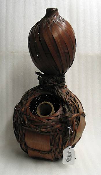 Appraisal: A woven gourd form ikebana basket Formed from thin and