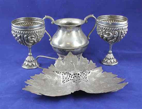 Appraisal: An Indian white metal leaf shaped dish in two goblets