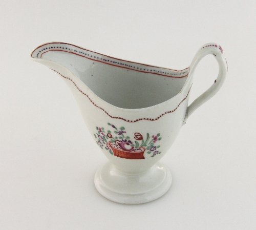 Appraisal: A New Hall helmet shaped cream jug painted a basket