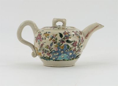 Appraisal: A miniature English salt-glazed teapot and cover painted with an