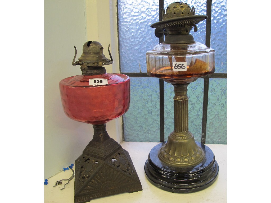 Appraisal: Two parafin lamps one with cranberry gass reservoir