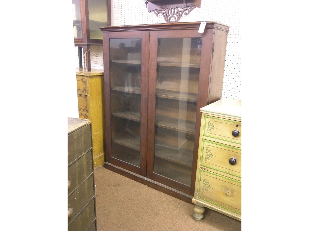 Appraisal: A Victorian walnut bookcase pair of glazed doors enclosing four