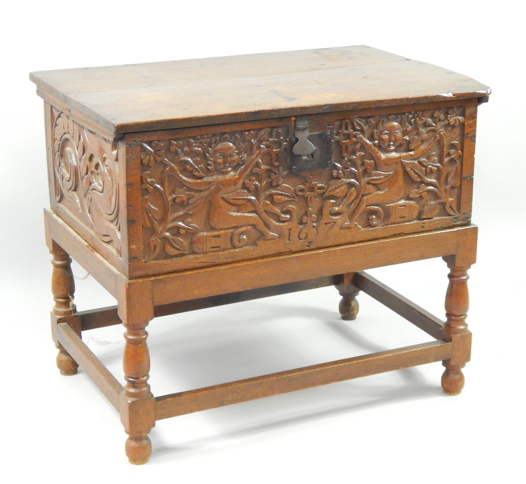 Appraisal: A thC oak chest carved to the sides with sea