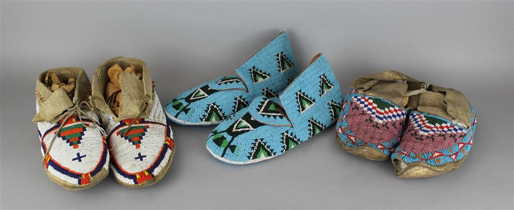 Appraisal: THREE PAIRS OF CHILD'S NATIVE AMERICAN BEADED HIDE MOCCASINS Provenance