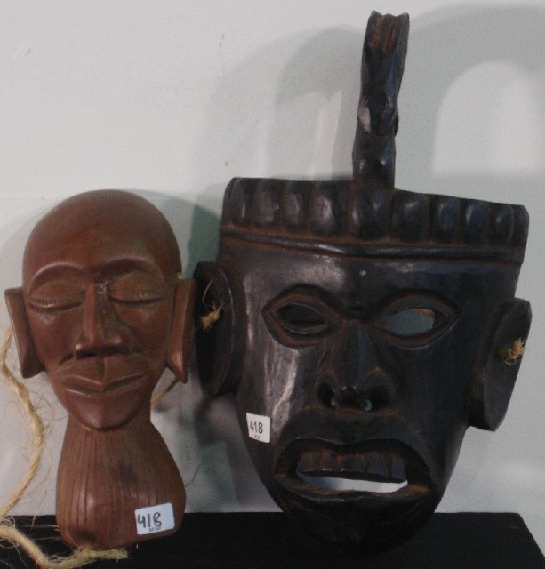 Appraisal: A black wooden African mask and a small brown African