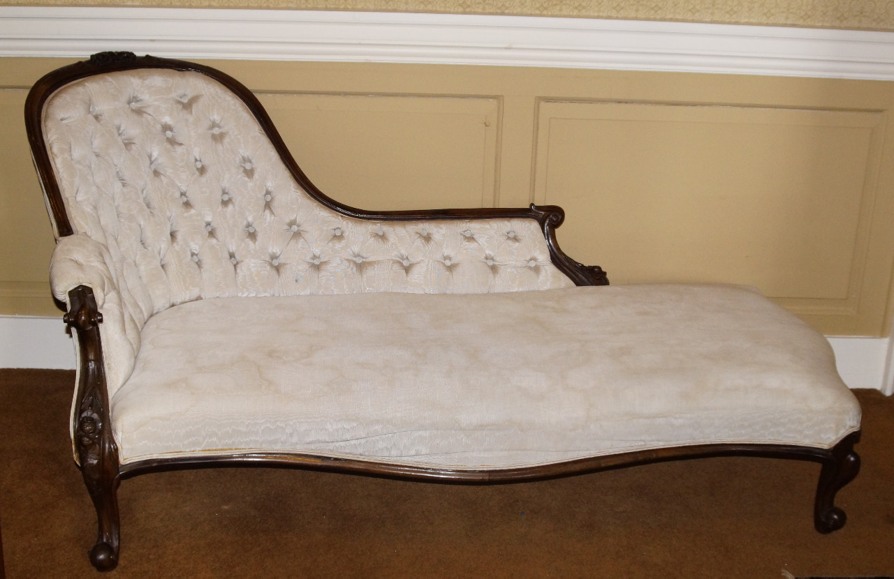 Appraisal: A Victorian walnut chaise longue the moulded show frame carved