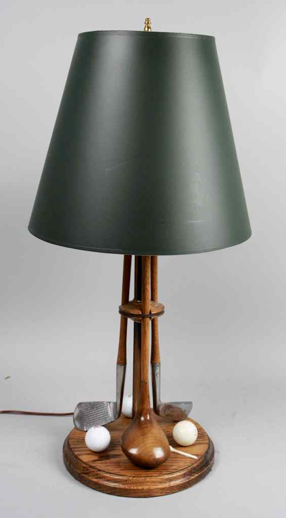 Appraisal: GOLFER'S TABLE LAMP The circular wood base fitted with two