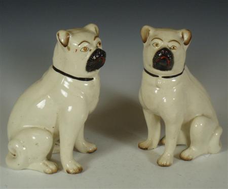 Appraisal: A pair of Staffordshire pottery figures of seated pugs each