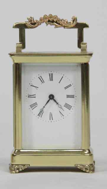 Appraisal: A gilt brass carriage time-piece with plain rectangular white dial