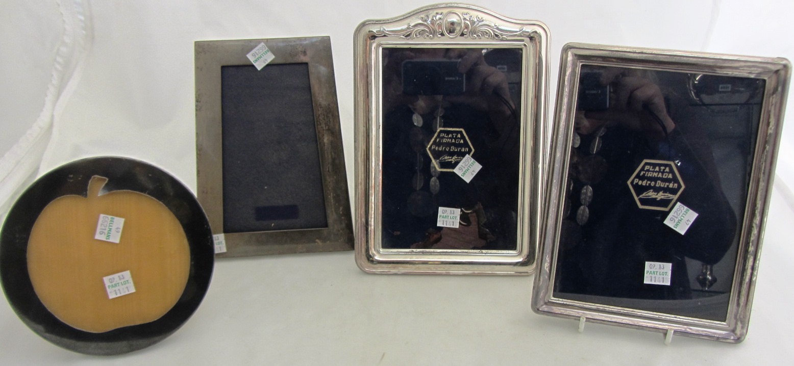 Appraisal: A rectangular photograph frame decorated with scrolling motifs detailed Sterling