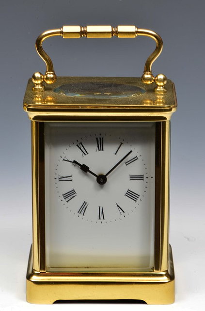 Appraisal: A FRENCH BRASS CARRIAGE TIMEPIECE with white enamel Roman dial