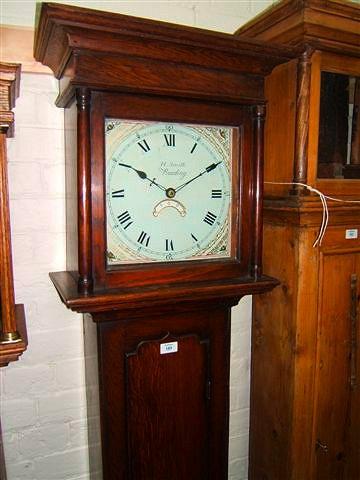 Appraisal: A late Georgian oak hour long case clock the square