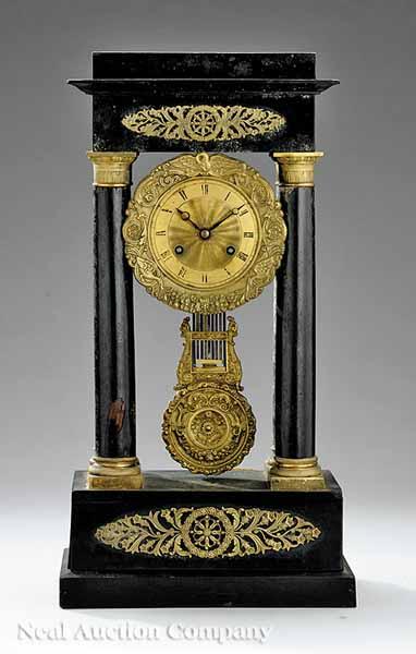 Appraisal: A French Empire Gilt Bronze and Ebonized Wood Portico Clock