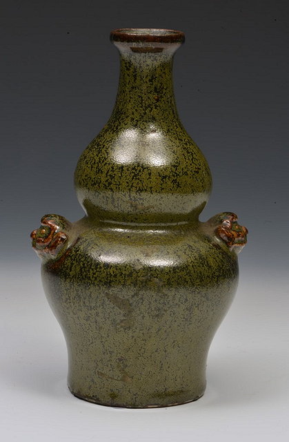 Appraisal: A CHINESE GREEN GLAZED DOUBLE GOURD VASE with mask handles