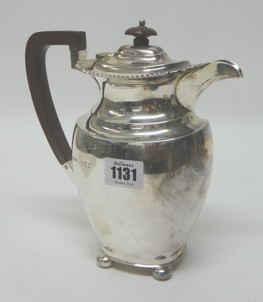 Appraisal: A silver hot water jug of ovoid form decorated with