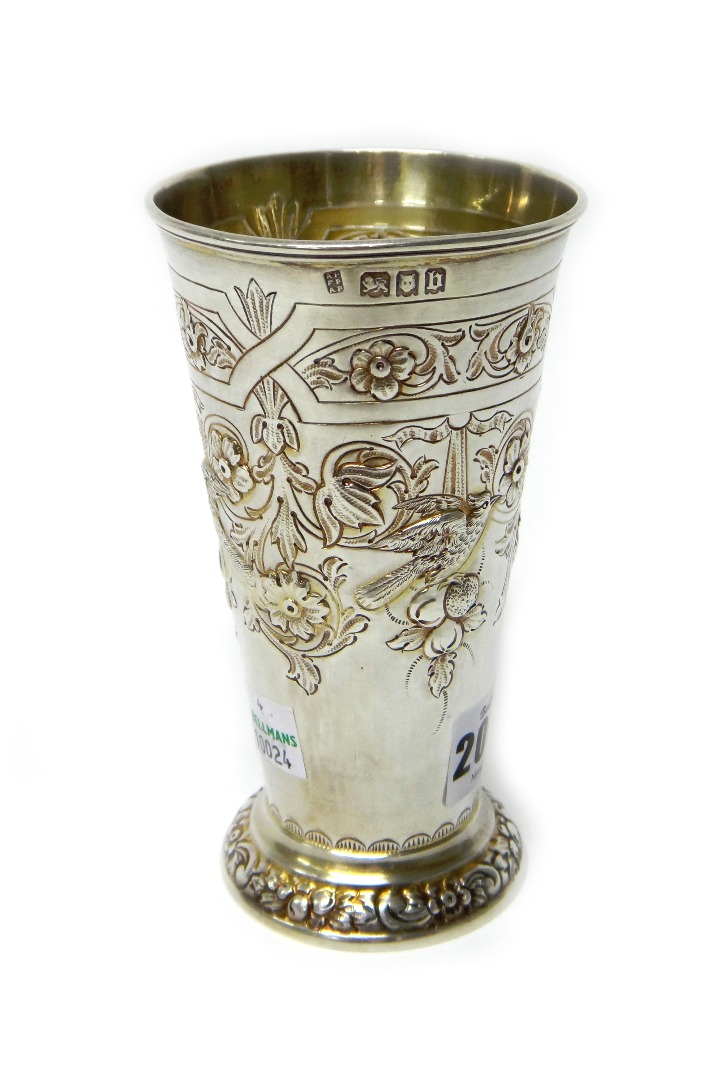 Appraisal: A silver vase of tapering cylindrical form embossed with birds