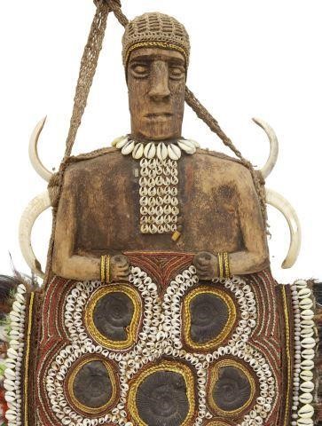 Appraisal: Carved wood ceremonial shield sculpture West Africa highly embellished with