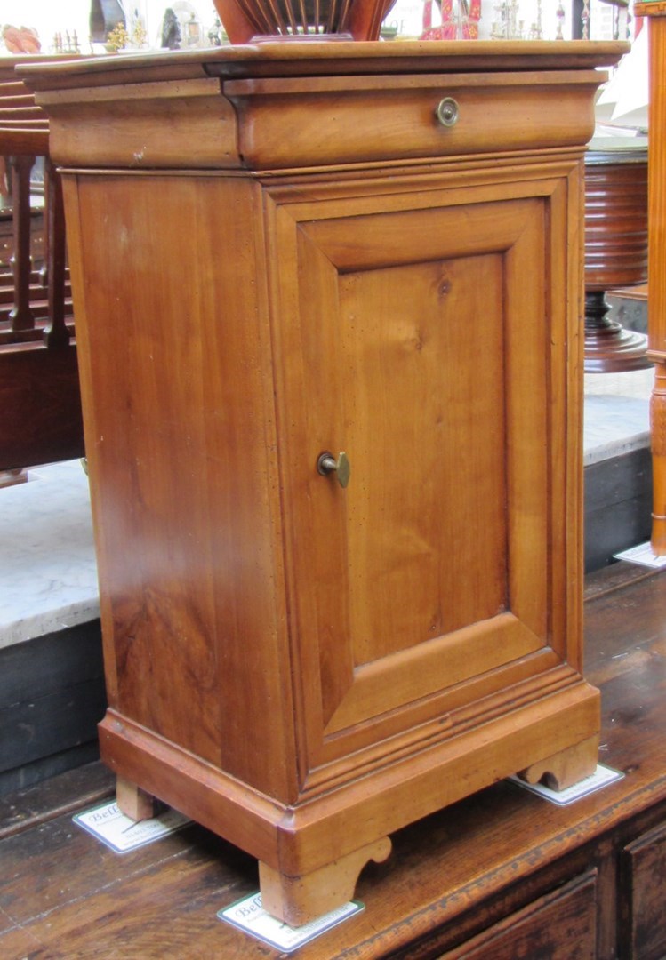 Appraisal: A th century French fruitwood bedside table with single drawer