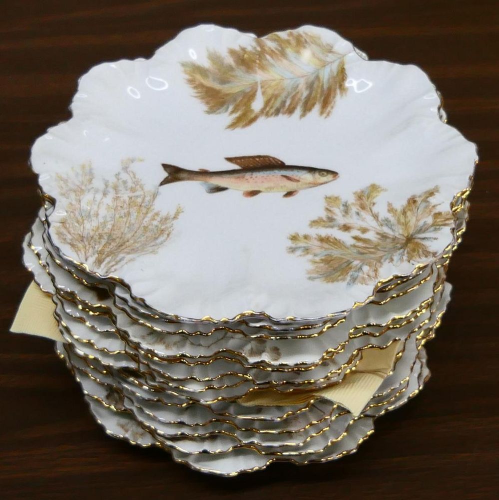 Appraisal: LIMOGES HAND PAINTED FISH SCALLOPED PLATES A set of French