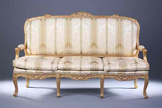 Appraisal: FRENCH ROCOCO STYLE GILT-WOOD CANAPE Elaborately carved cartouche-form padded back