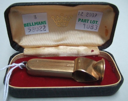 Appraisal: A gold mounted folding cigar cutter detailed with a case