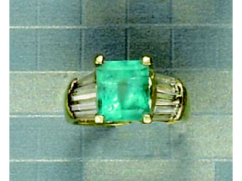 Appraisal: EMERALD AND DIAMOND RING k yellow gold ring centering one