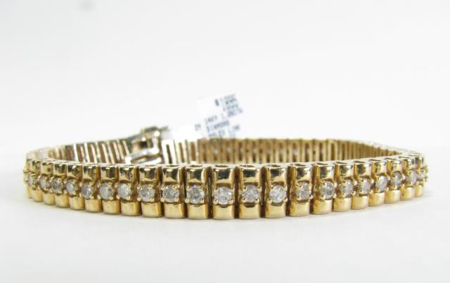 Appraisal: A K yellow gold Rolex style diamond tennis bracelet with