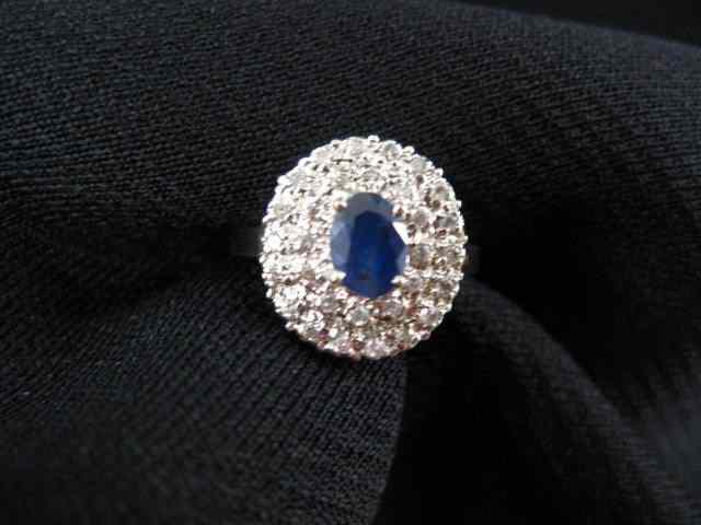 Appraisal: Sapphire Diamond Ring carat oval gemsurrounded by diamonds totaling carat