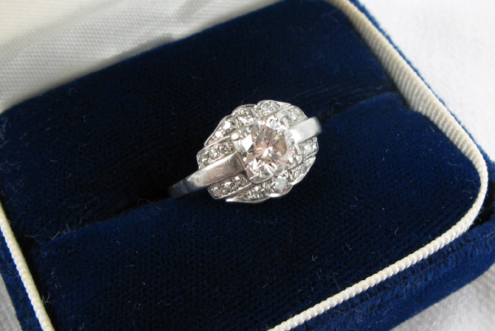 Appraisal: ESTATE DIAMOND AND PLATINUM RING centering a round brilliant-cut diamond