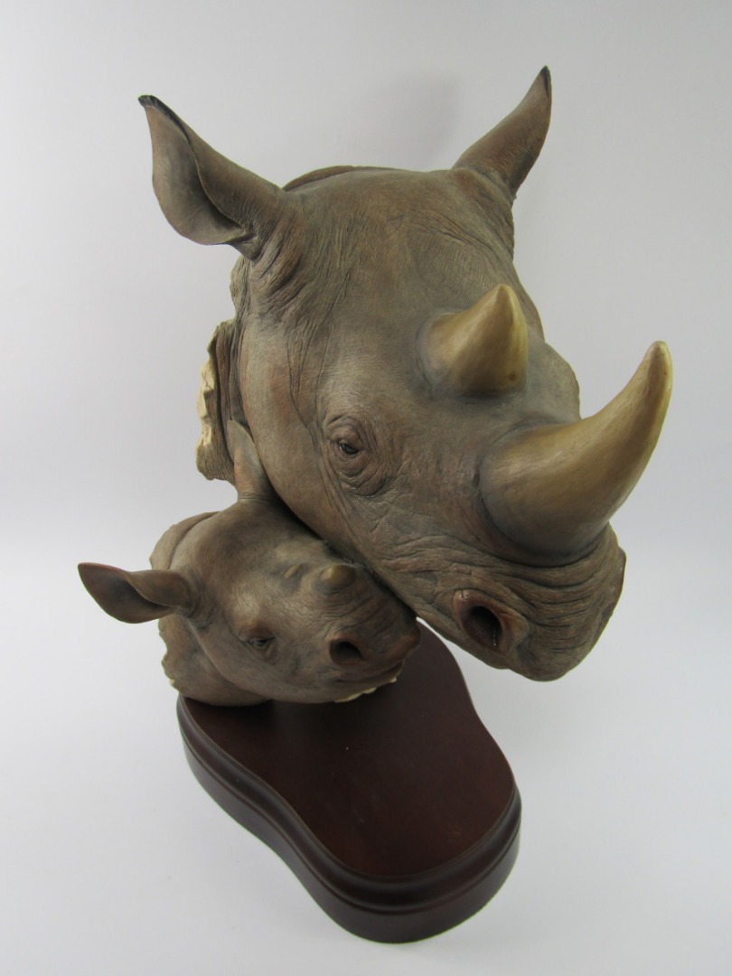 Appraisal: A modern resin sculpture of a rhino's head with young