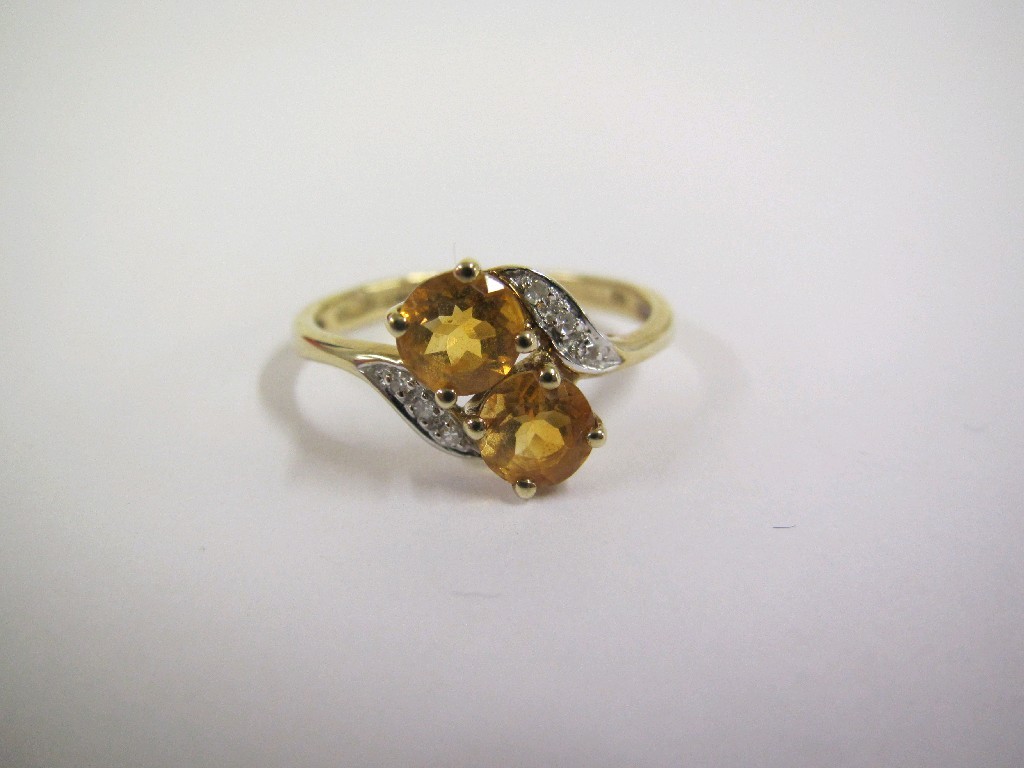 Appraisal: Nine carat gold citrine two stone twist ring with diamond