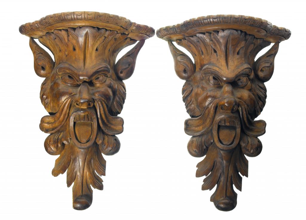 Appraisal: A PAIR OF VICTORIAN CARVED WALNUT GROTESQUE WALL BRACKETS the