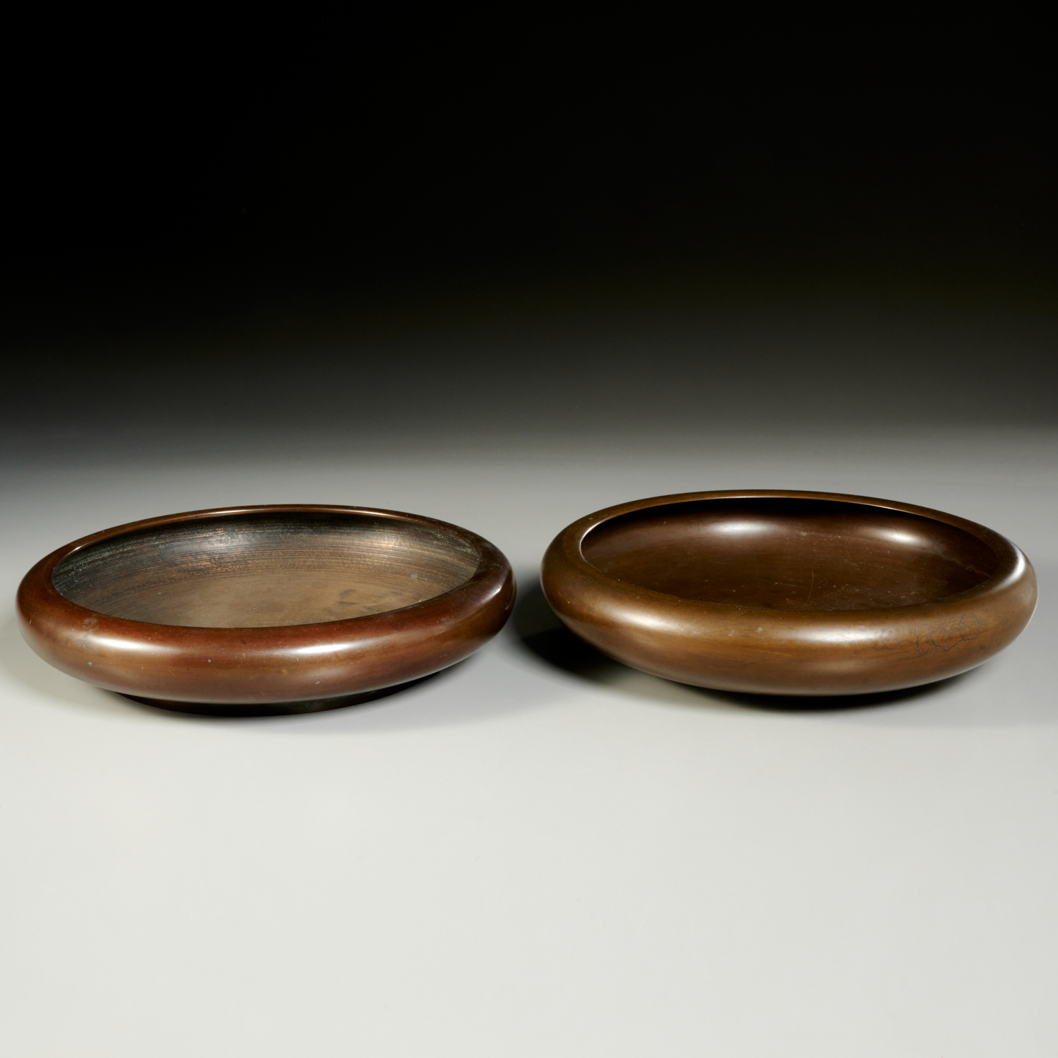 Appraisal: NEAR PAIR ASIAN BRONZE SHALLOW CIRCULAR BOWLS th c natural