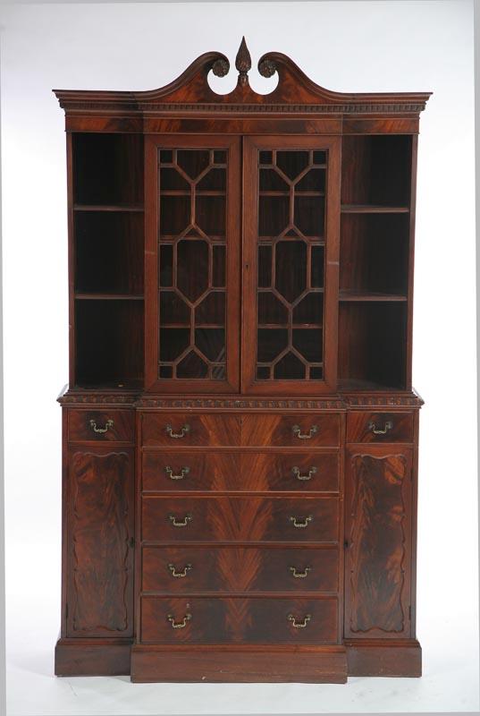 Appraisal: CHIPPENDALE STYLE BREAKFRONT CABINET Mahogany with a broken arch pedimaent