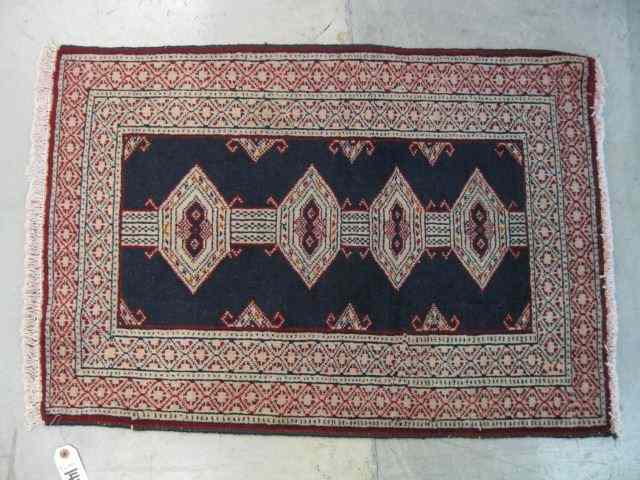 Appraisal: Turkman Persian Handmade Mat geometrics indigo field ivory red trim