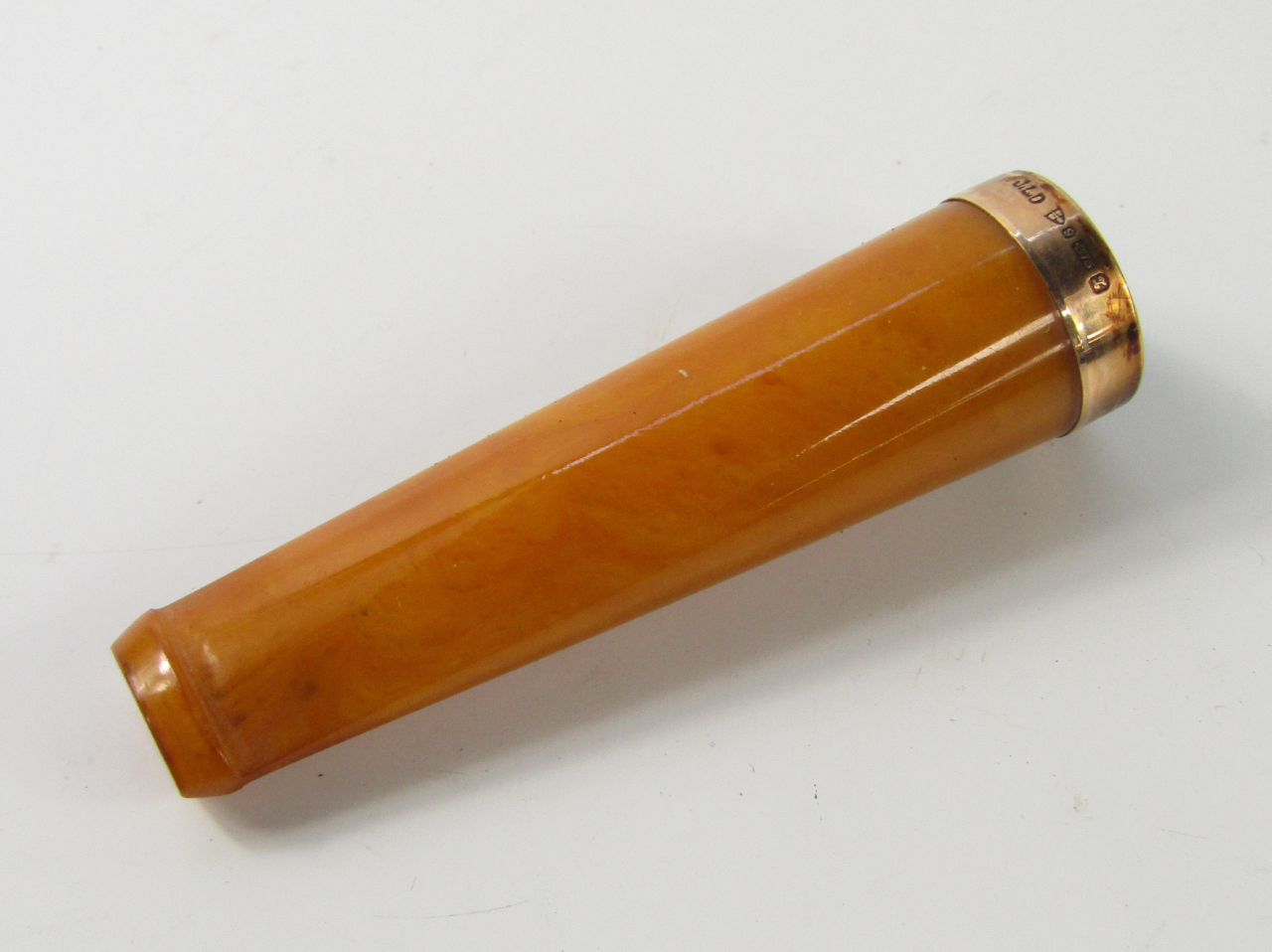 Appraisal: An amber cheroot holder with ct gold mount in Rexala