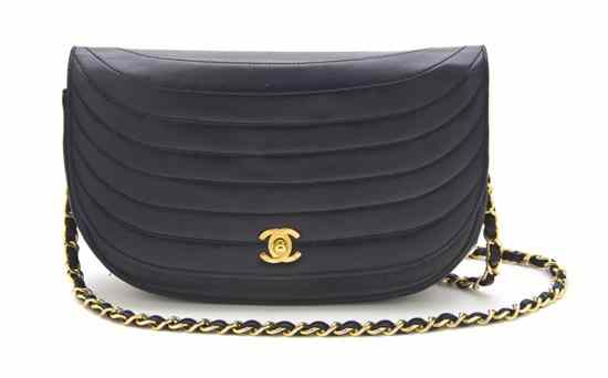 Appraisal: A Chanel Navy Leather Bag in a squared crescent shape